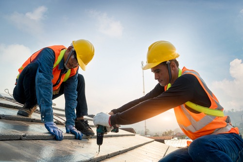 Construction workers working on a roof