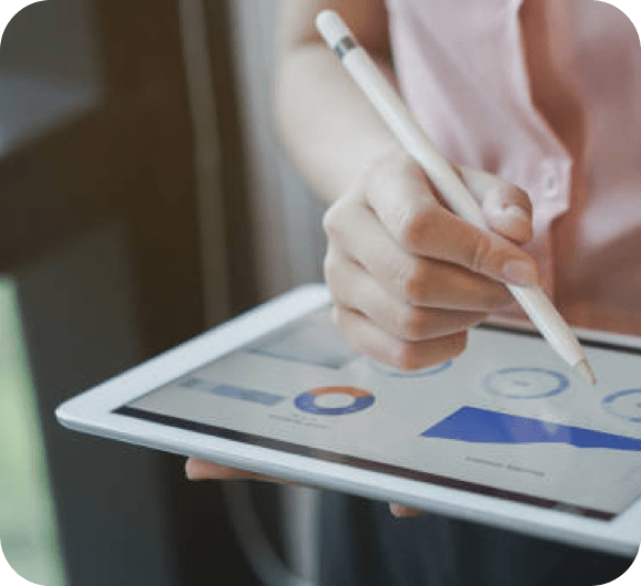 a hand holding a pen to type on a tablet showing graphics